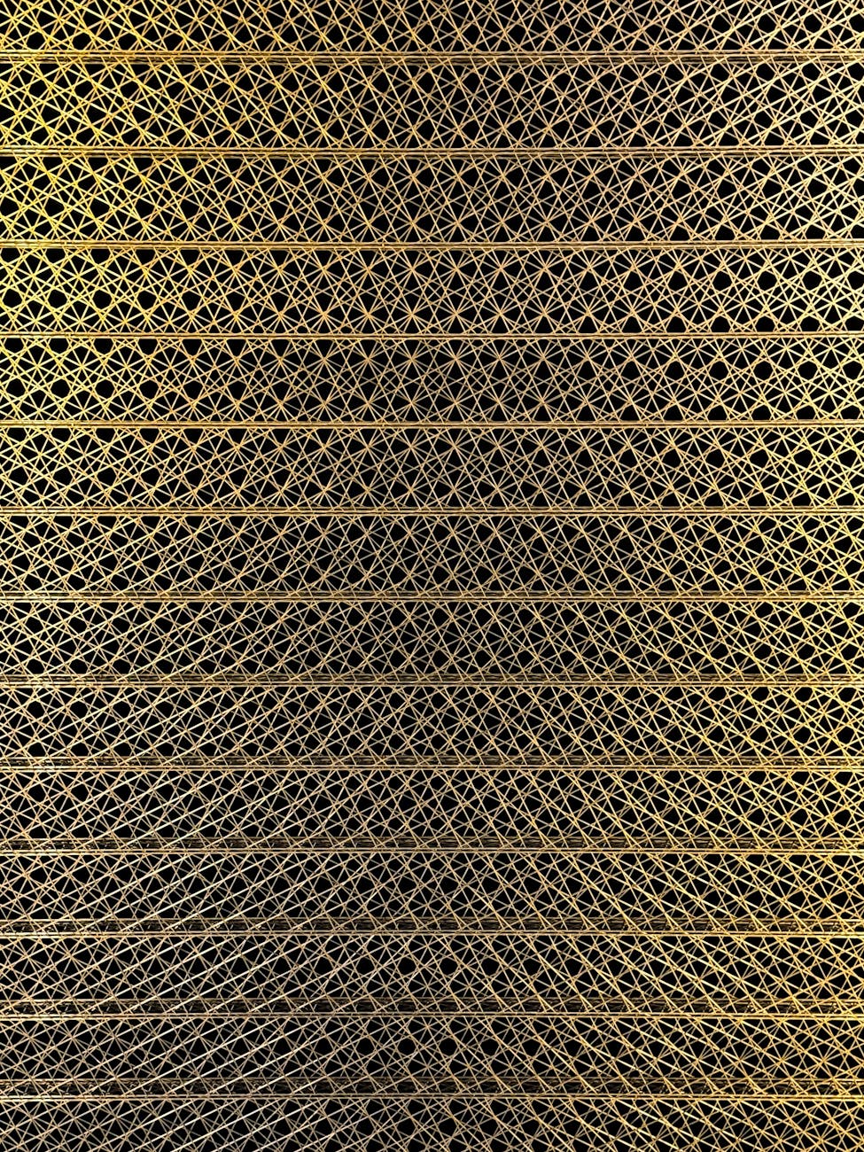 Close-up of a gold mesh design showcasing intricate and ornate patterns in vertical alignment.