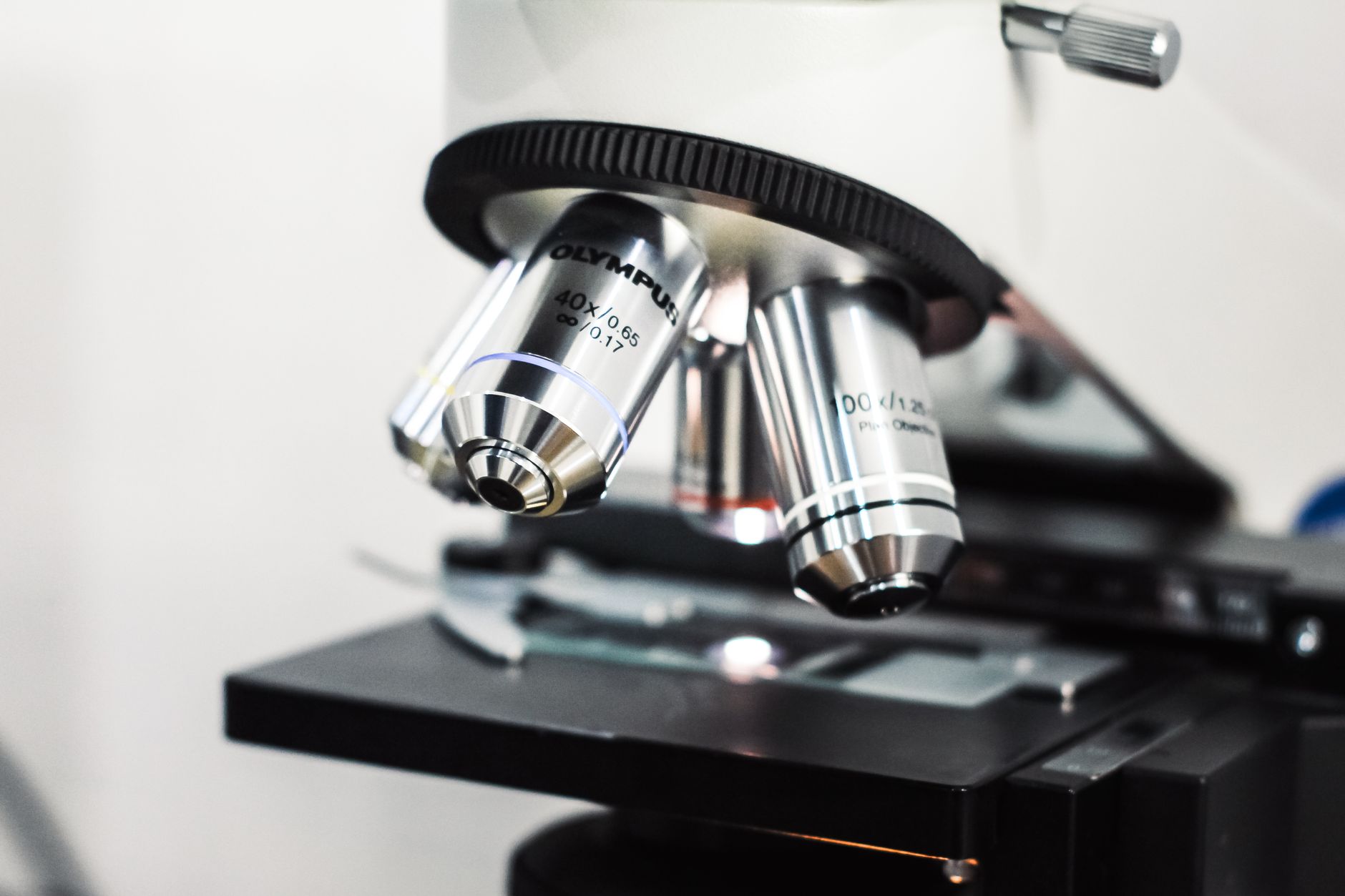 Detailed view of an Olympus microscope used for scientific research in a laboratory setting.