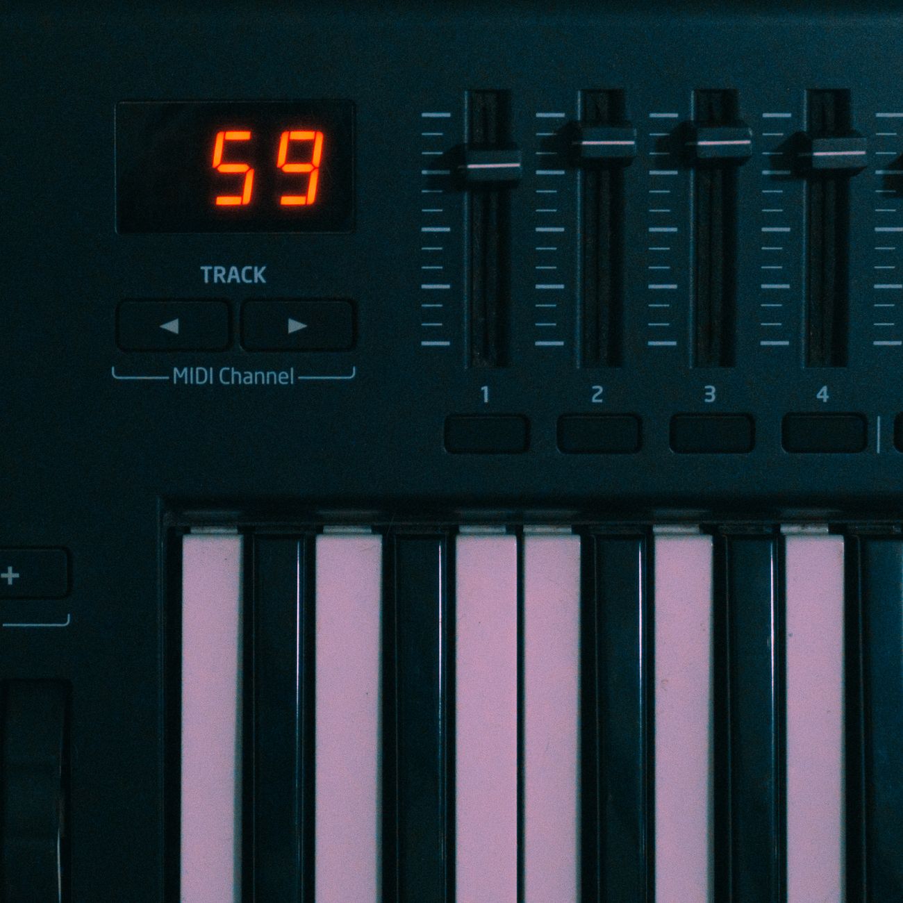 Close-up of a MIDI keyboard with digital display and controls.