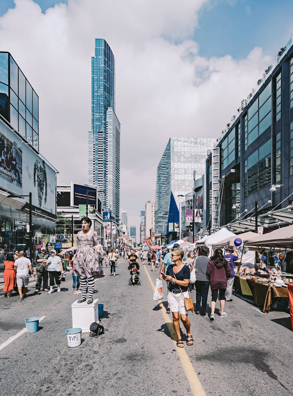Vibrant street scene in Toronto with performers, people, and skyscrapers.