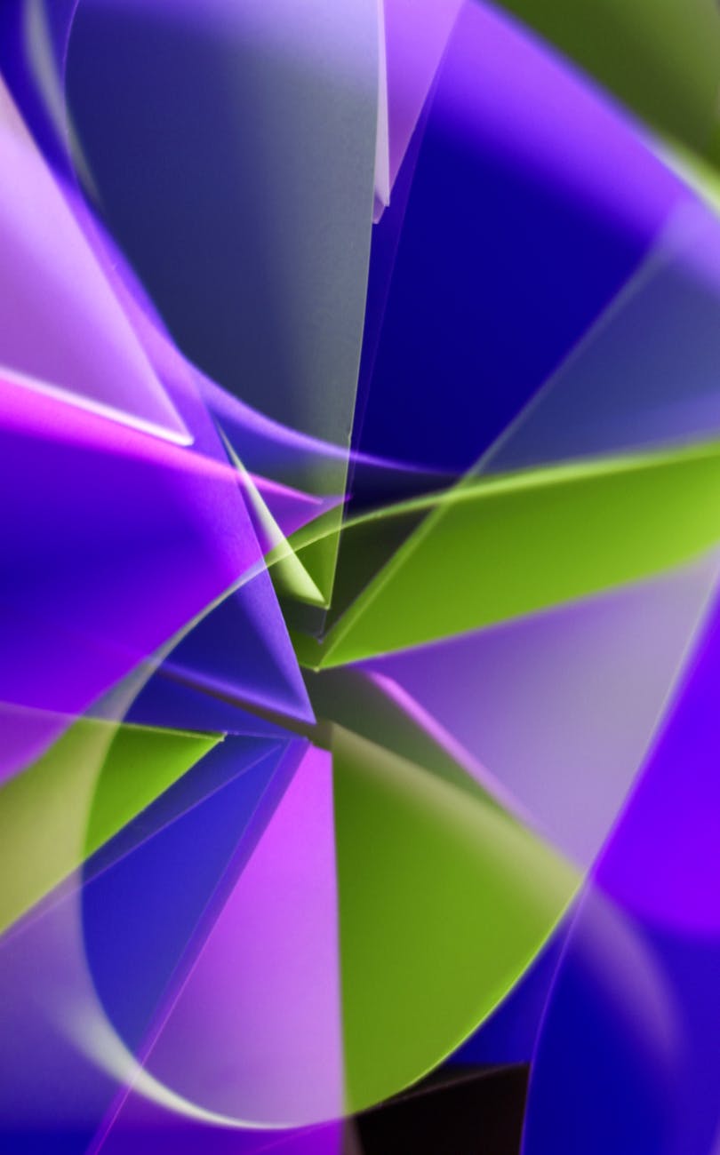 Vivid abstract artwork with bold geometric shapes in vibrant purple and green hues.