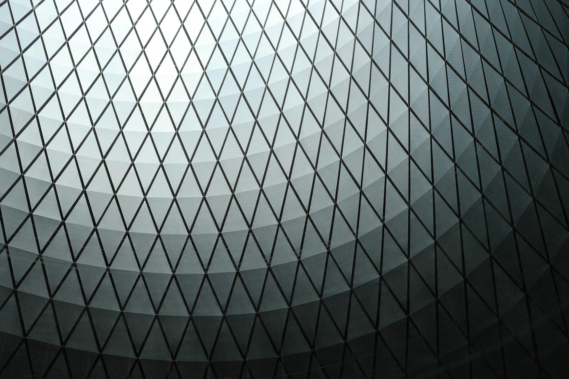 Abstract view of a geometric dome ceiling with a diamond pattern in black and white tones.