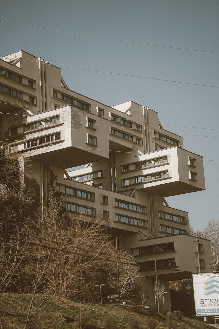 Modernist architectural building with protruding sections in an urban setting captured during daytime.