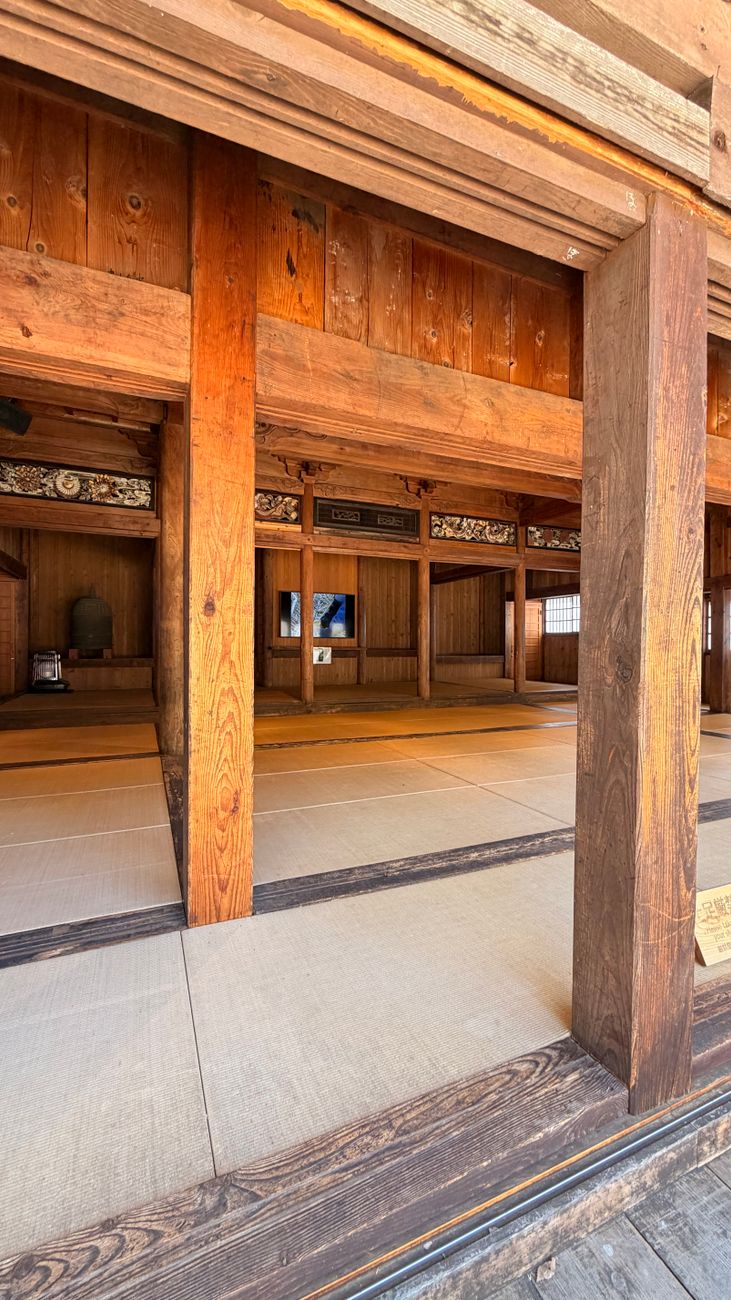 Interior view of a traditional Japanese tatami room in Shirakawa, Japan, showcasing wooden architecture and serene design.