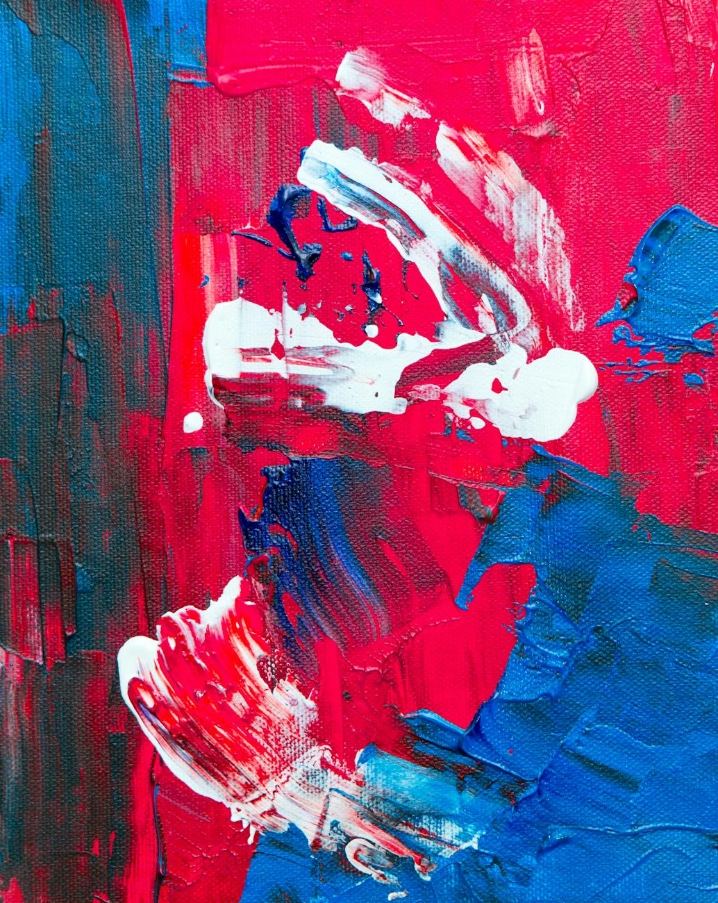 Colorful abstract painting with bold red and blue acrylic strokes on canvas.