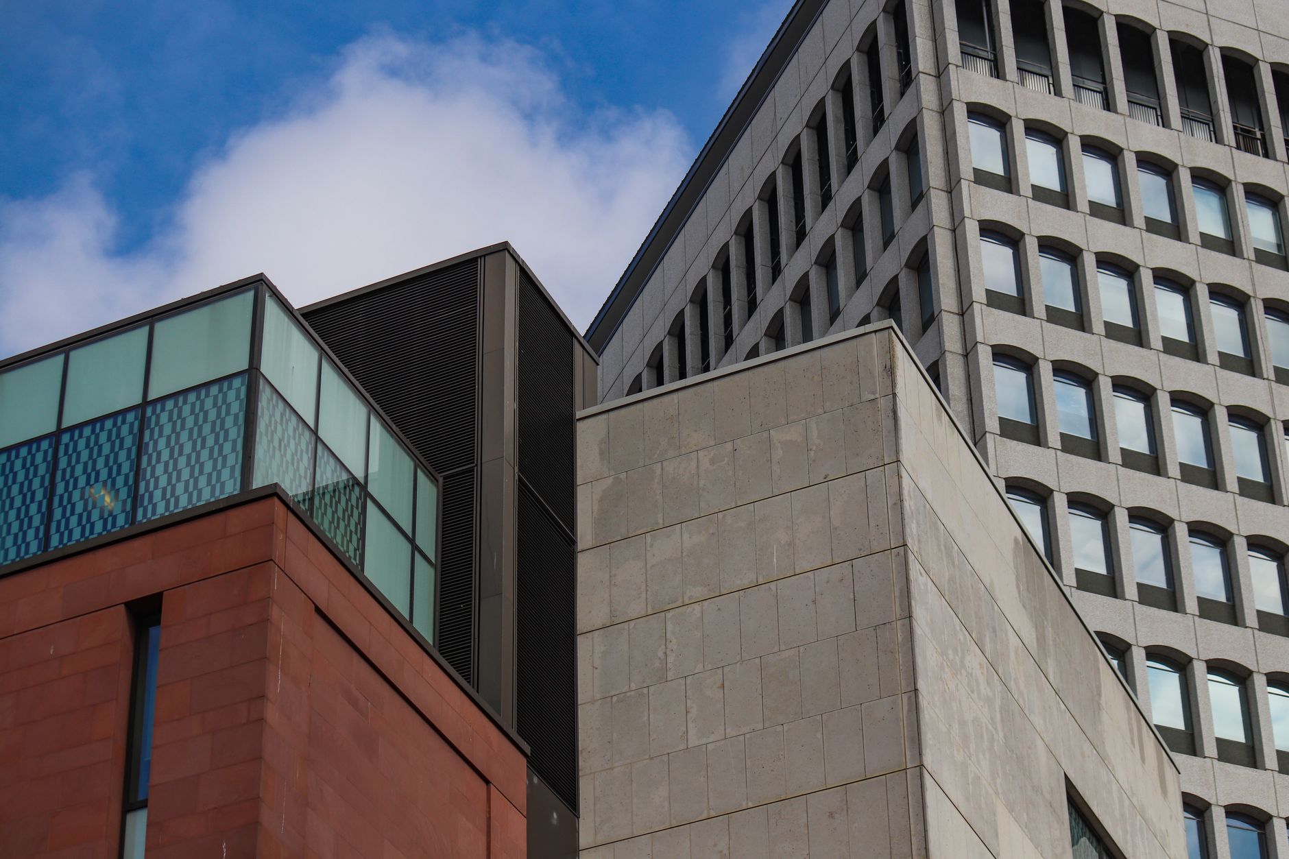 A striking view of modern architecture against a clear blue sky, showcasing geometric forms.