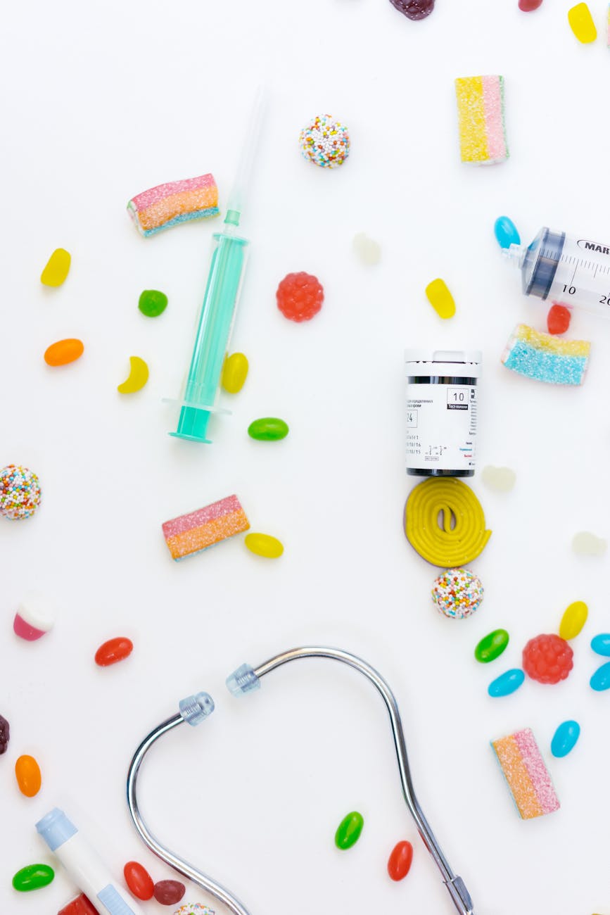 A flat lay of medical items and candies, highlighting sweet temptation and health care concerns.