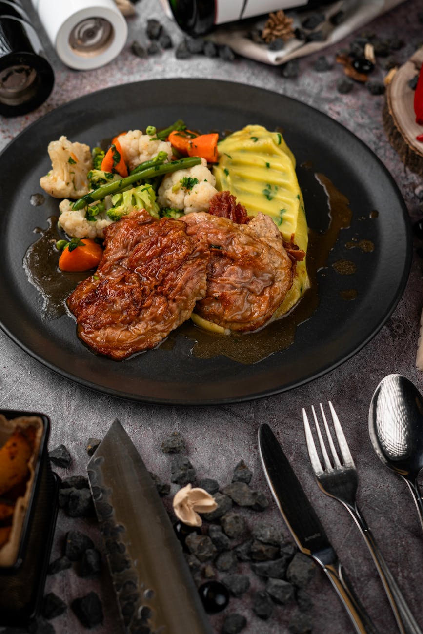 Savor a gourmet steak dinner with mashed potatoes and vegetables, ideal for food enthusiasts.