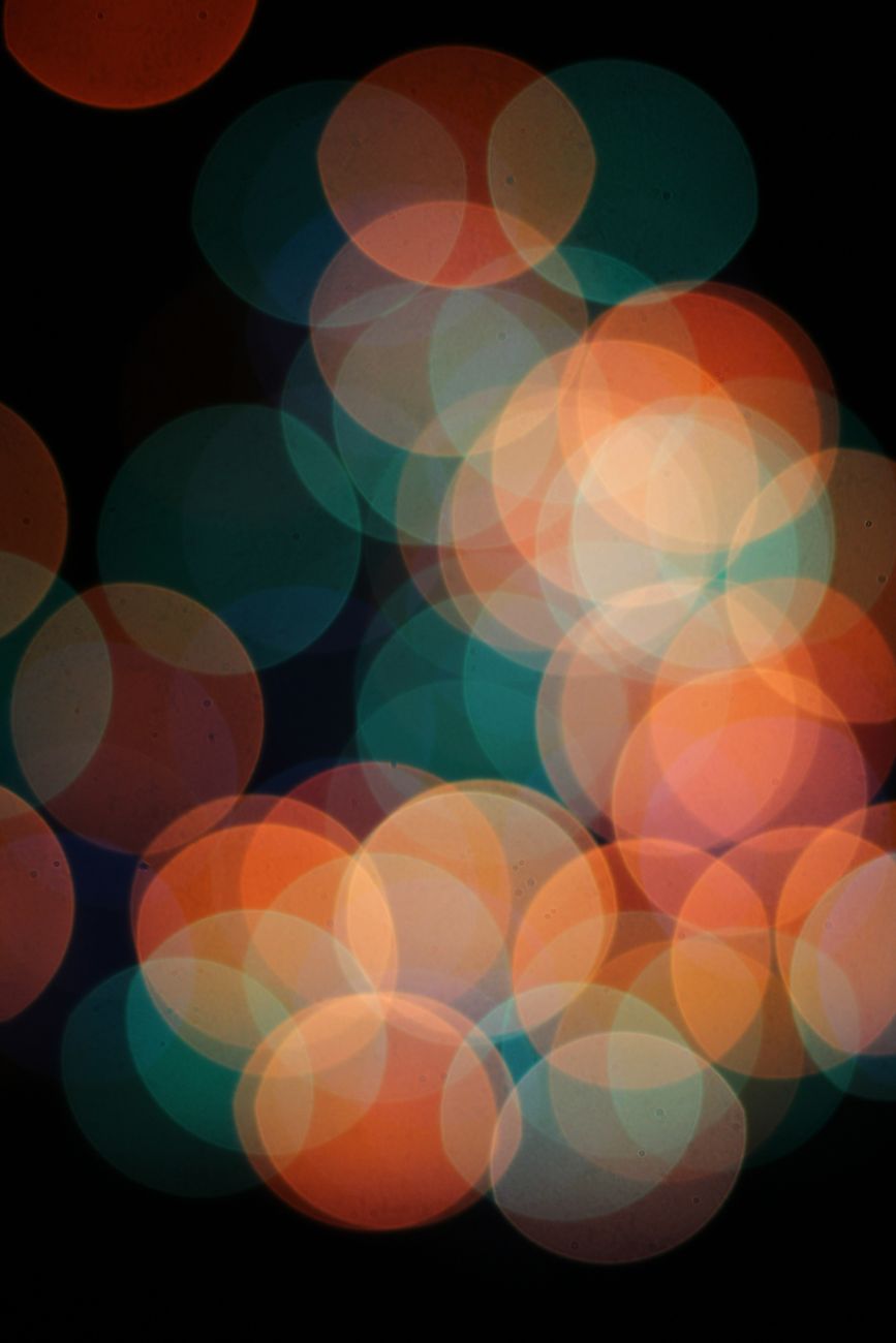 Vibrant bokeh circles in various colors on a dark background, creating a striking abstract design.