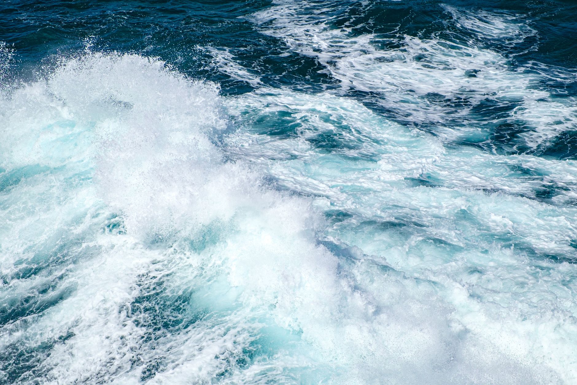 Dynamic ocean waves splashing and foaming, capturing the sea's powerful movement.