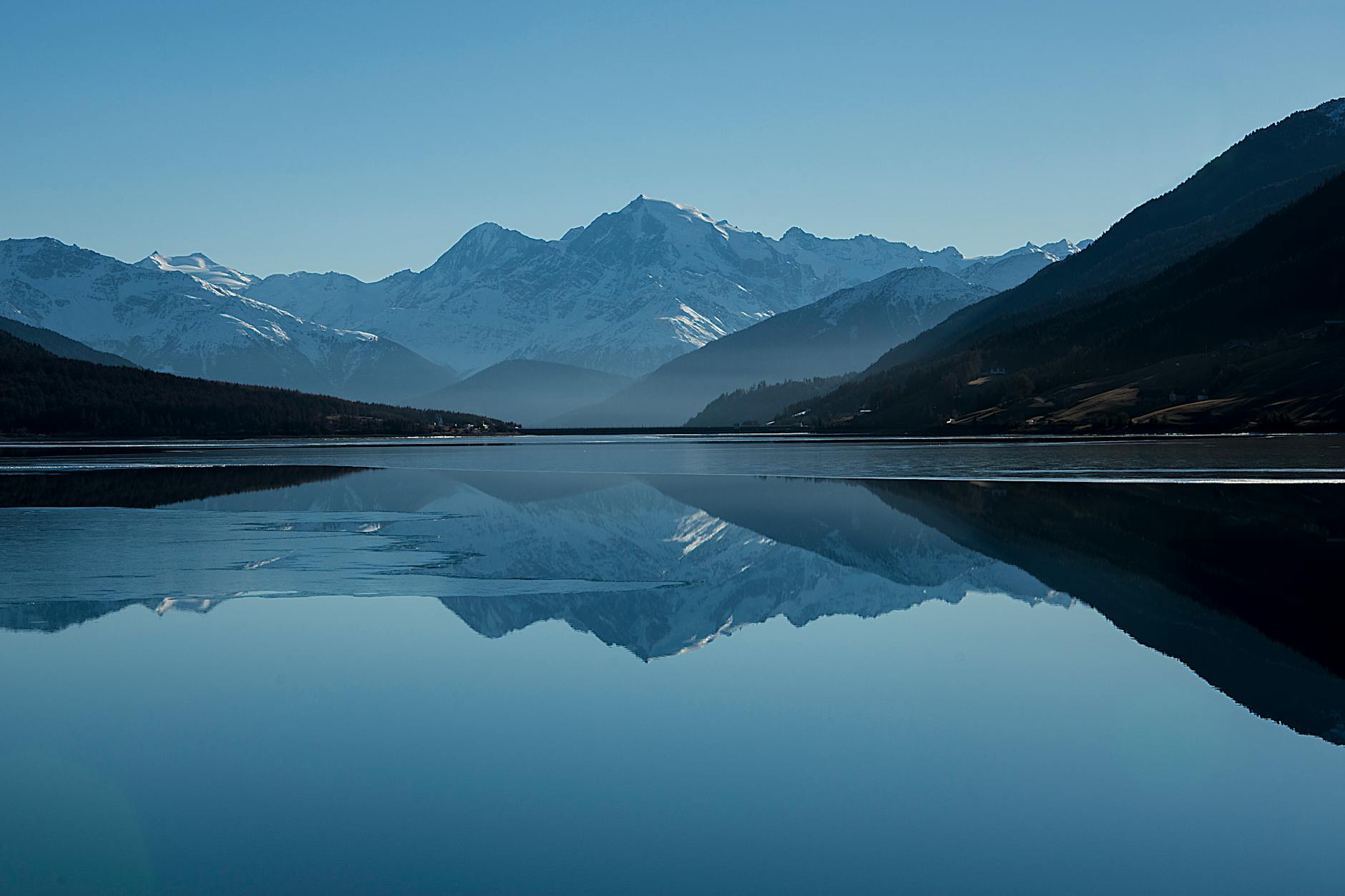 Peaceful mountain landscape with clear reflections in a calm lake.