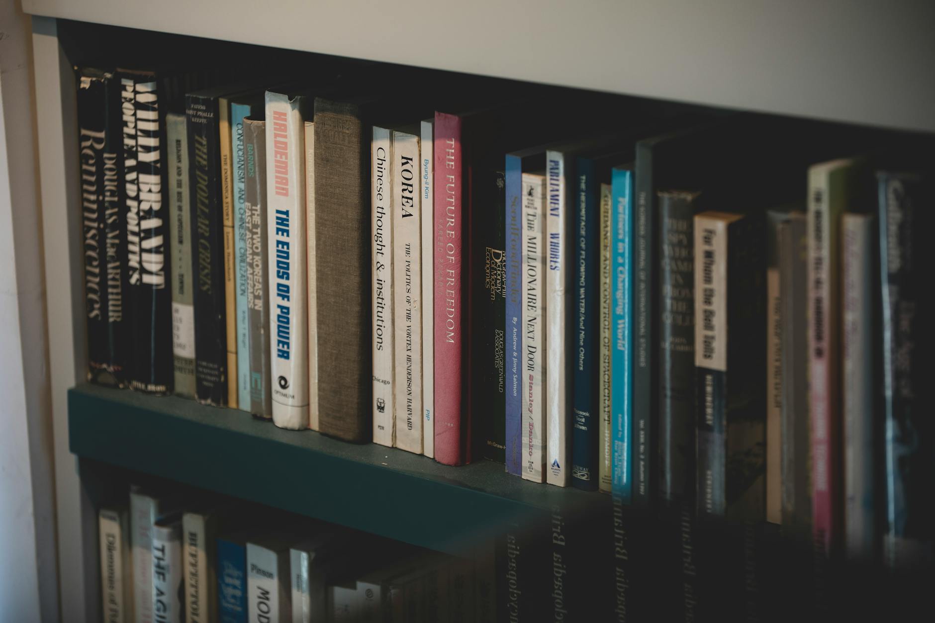 A close-up of a bookshelf filled with diverse books on various subjects, ideal for education and study.