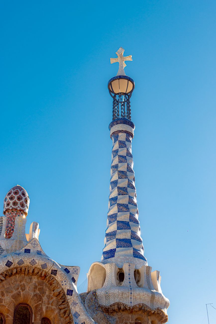 Detail of a mosaic spire in Park Güell, Barcelona, showcasing iconic Catalan architecture.
