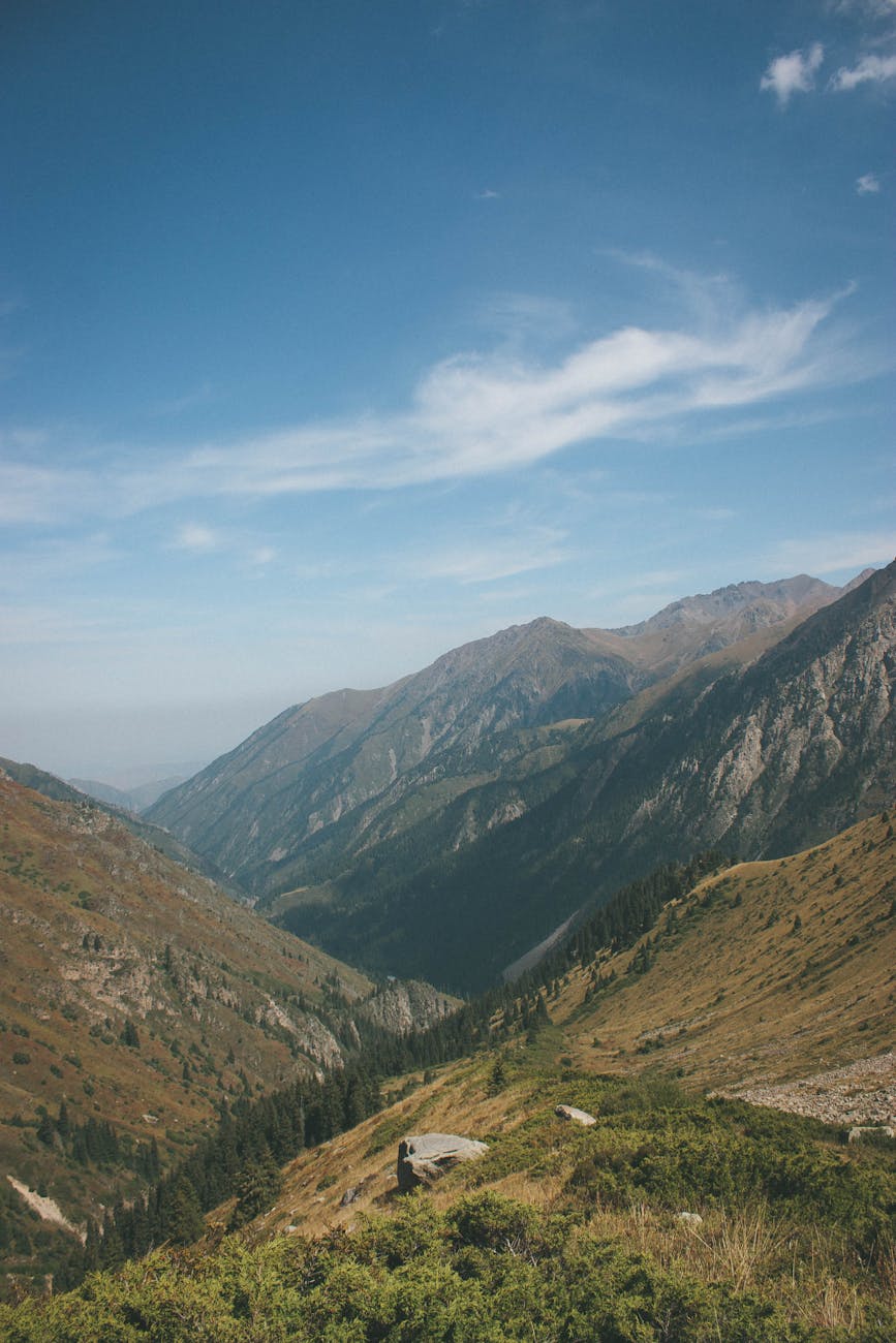 Stunning mountain landscape near Almaty, Kazakhstan with deep valleys and clear blue skies.