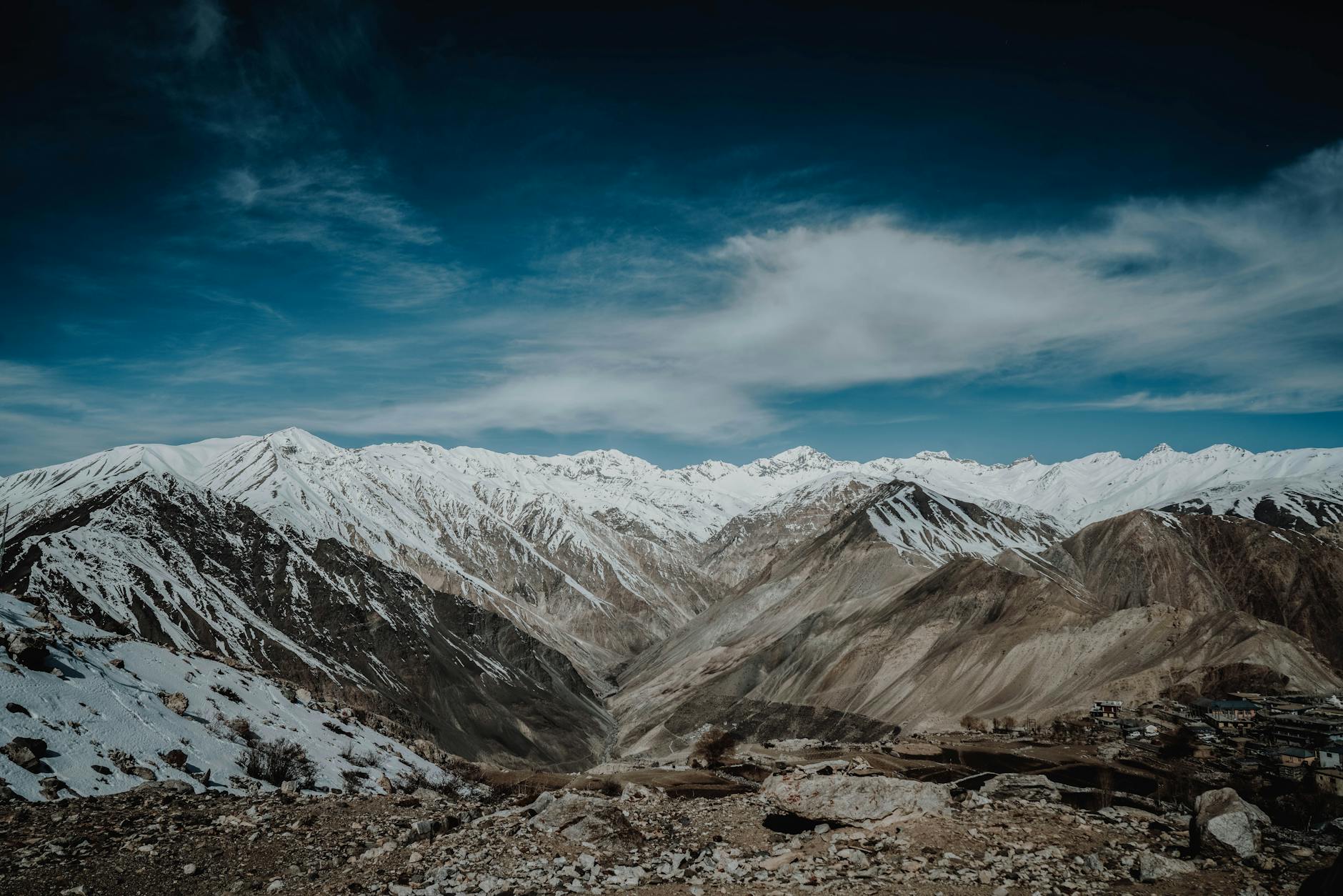 Stunning snowy mountain landscape under a dramatic sky captured outdoors.