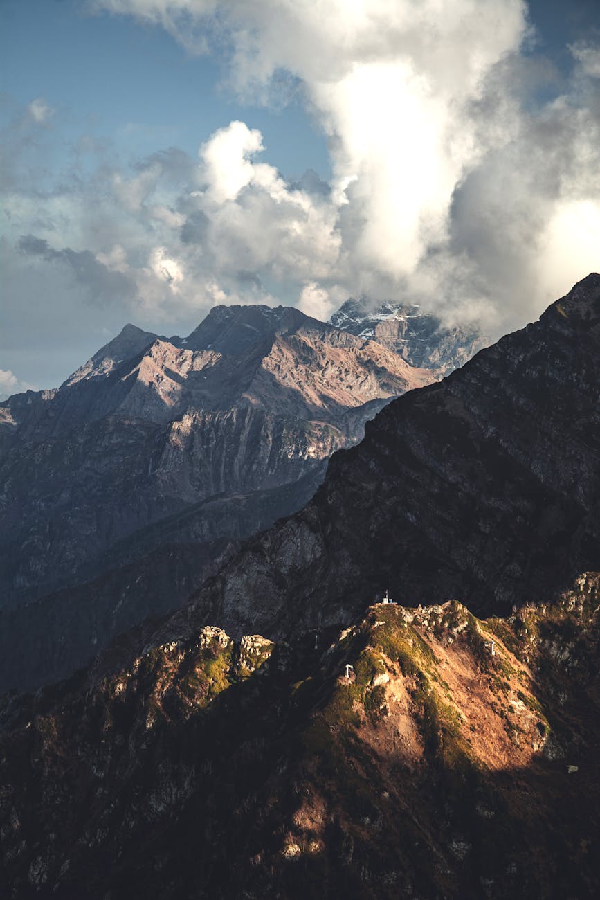 Stunning mountain landscape with cloud formations over rocky peaks in Sochi, showcasing nature's beauty.