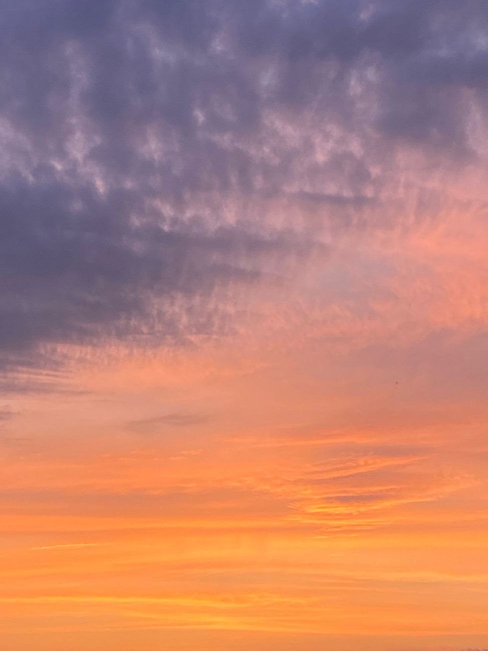 A stunning sunset sky filled with vibrant colors and dramatic cloud formations.