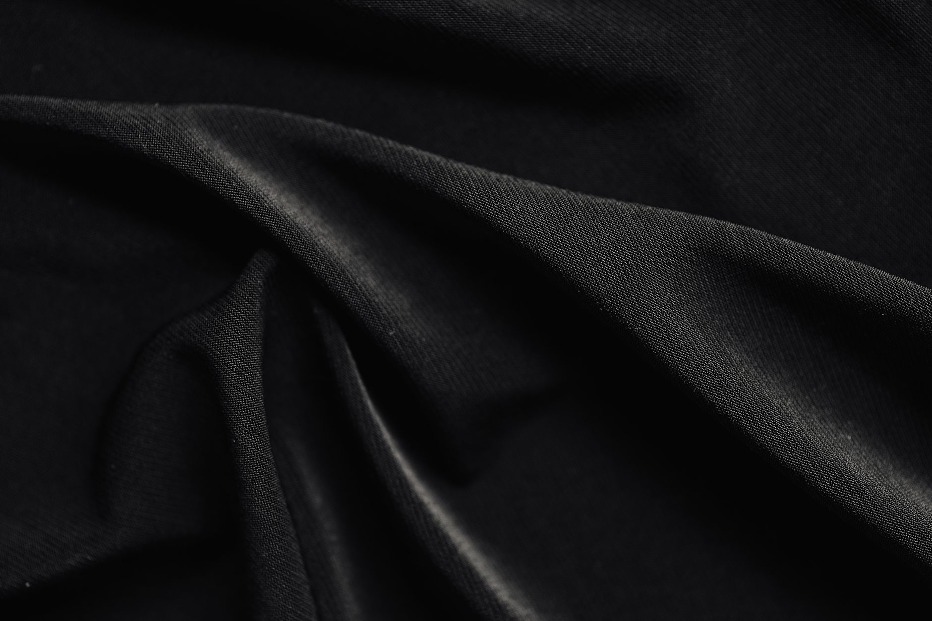 Detailed close-up of black fabric folds showcasing texture and material.