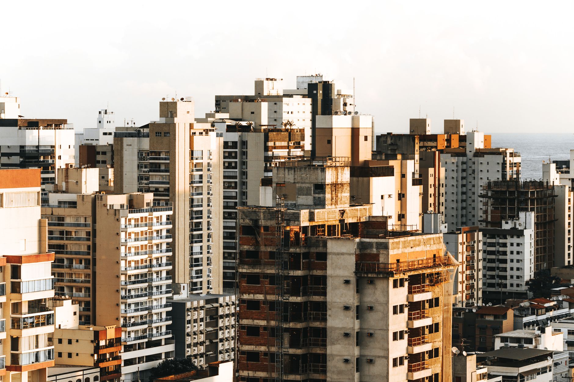 Aerial view of diverse urban architecture with high rise buildings in daylight.