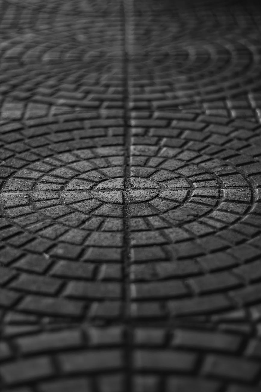 Intricate geometric patterns on a concrete surface in grayscale. Ideal for backgrounds.