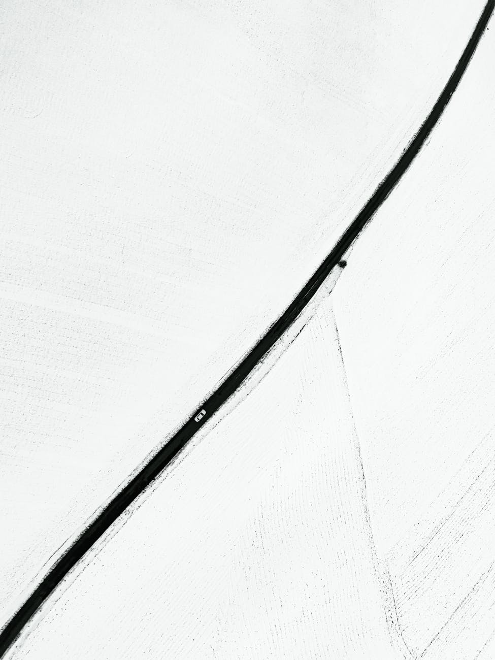 Aerial view of a minimalist snow-covered road in Gölbaşı, Adıyaman, Türkiye.