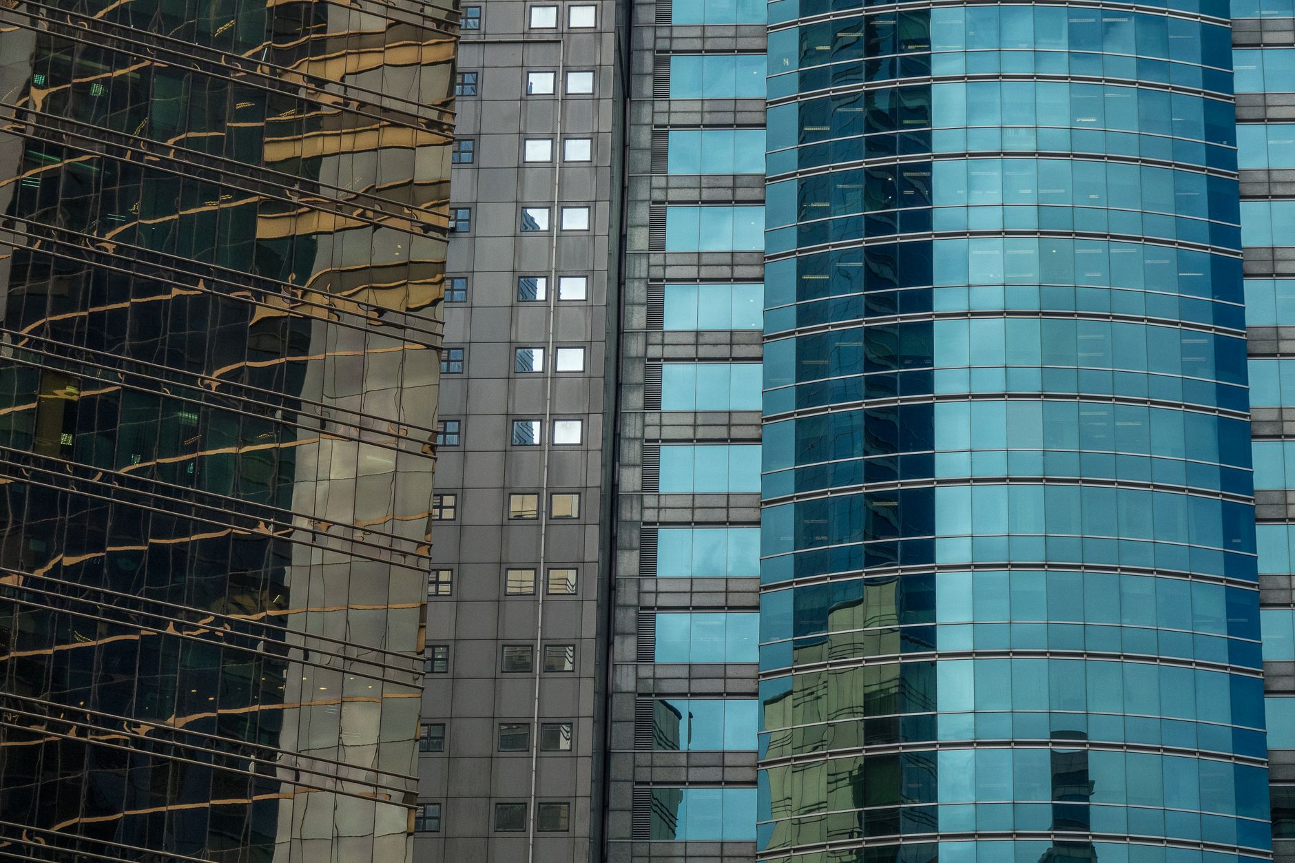 An urban cityscape of skyscraper facades with glass reflections showcasing modern architecture.