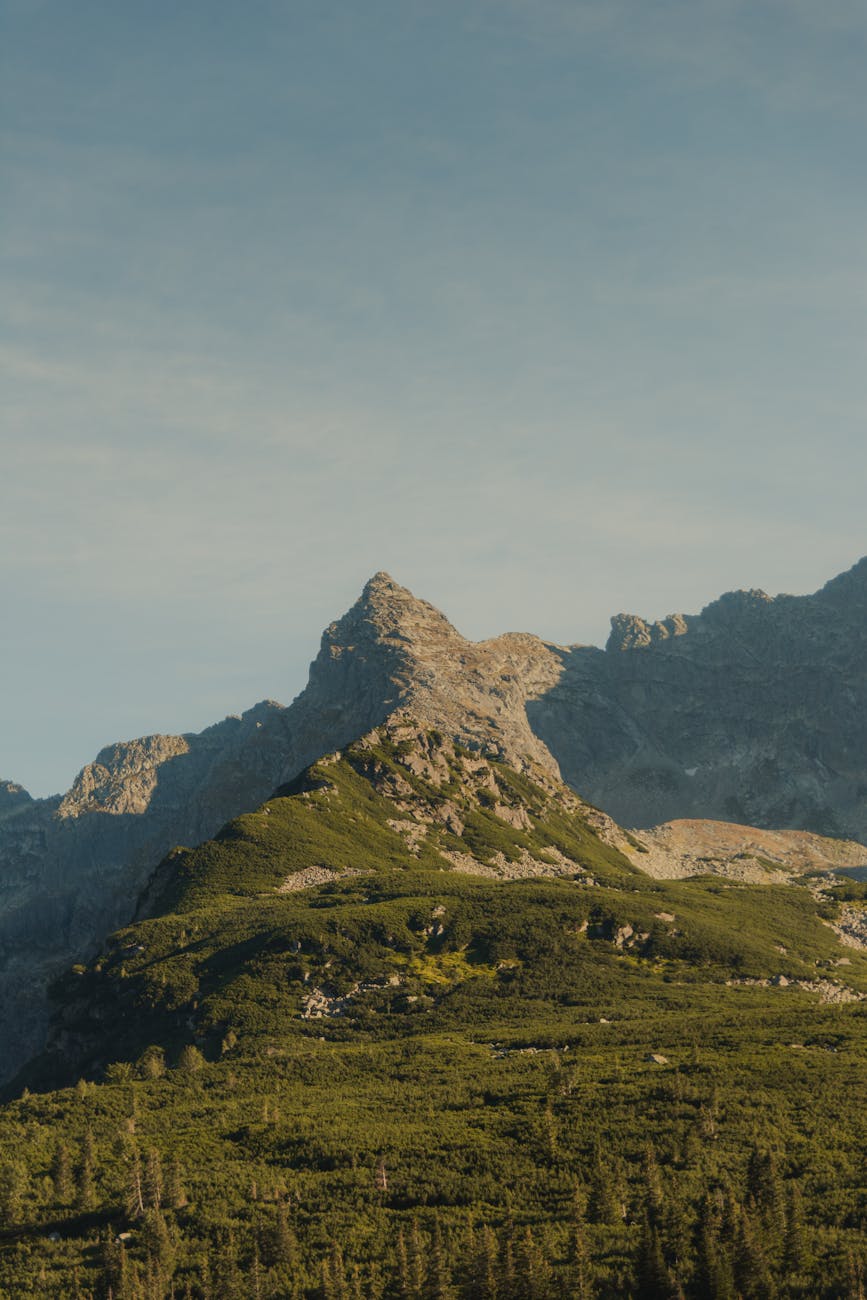 A serene view of a mountain peak captured during sunrise, showcasing nature's beauty.