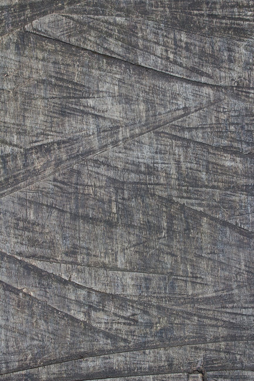 Close-up of textured weathered wood surface showing natural patterns and grain details.