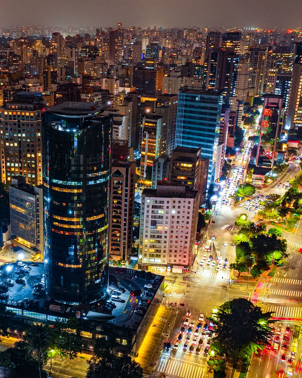 A dazzling night view of São Paulo showcasing illuminated skyscrapers and bustling city streets.
