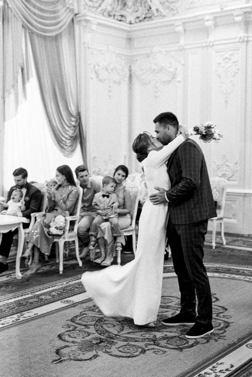 A romantic moment between bride and groom during an indoor wedding ceremony.