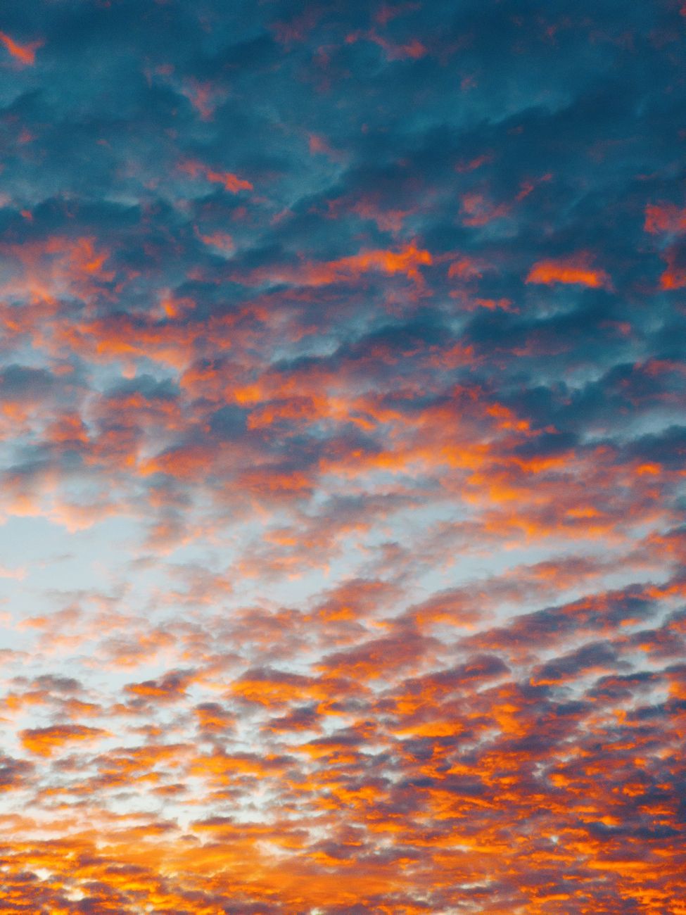 Dramatic sky with vibrant orange and purple clouds during sunset in Brazil, creating a stunning natural backdrop.
