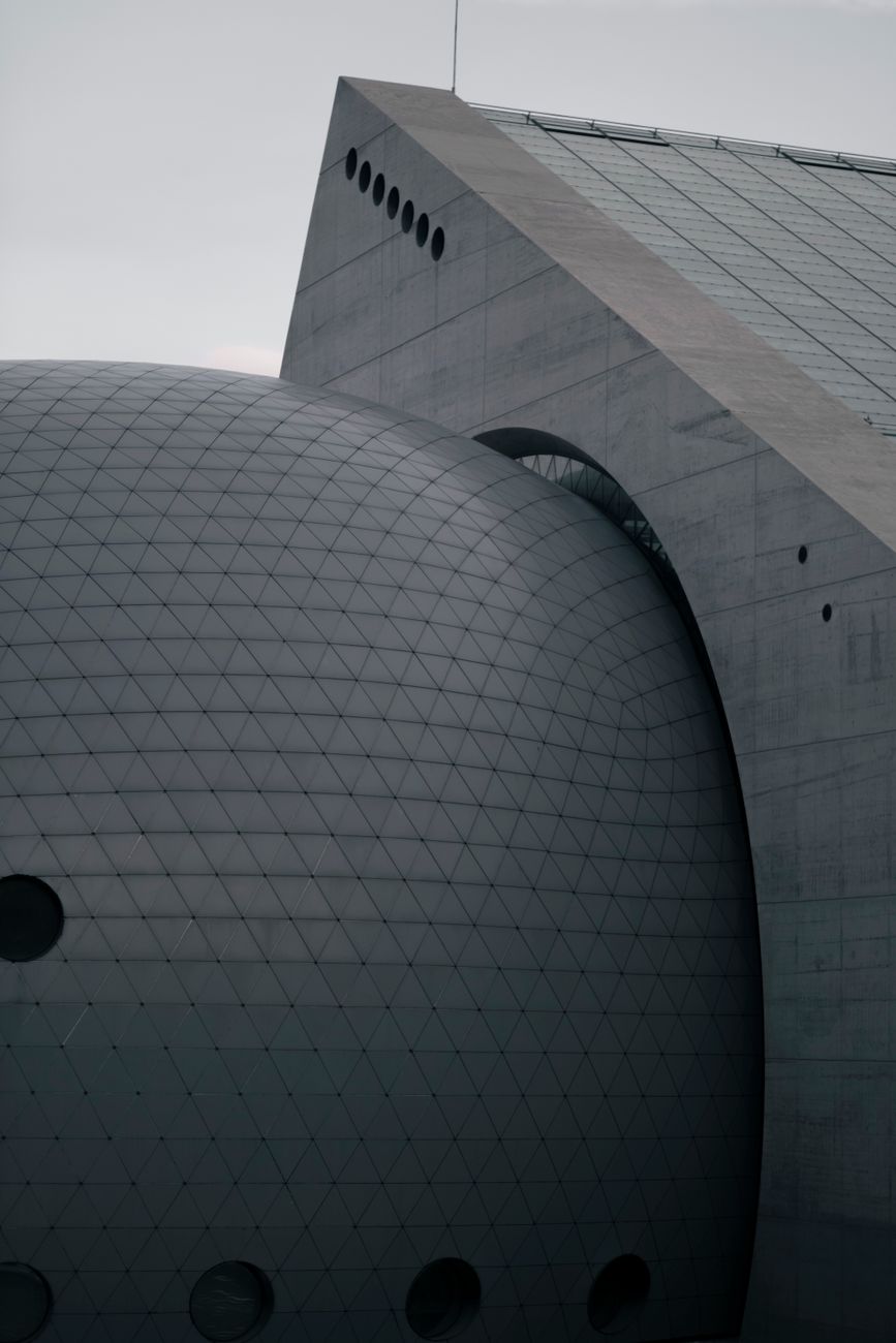 Close-up of a modern building with geometric patterns and unique architectural design.