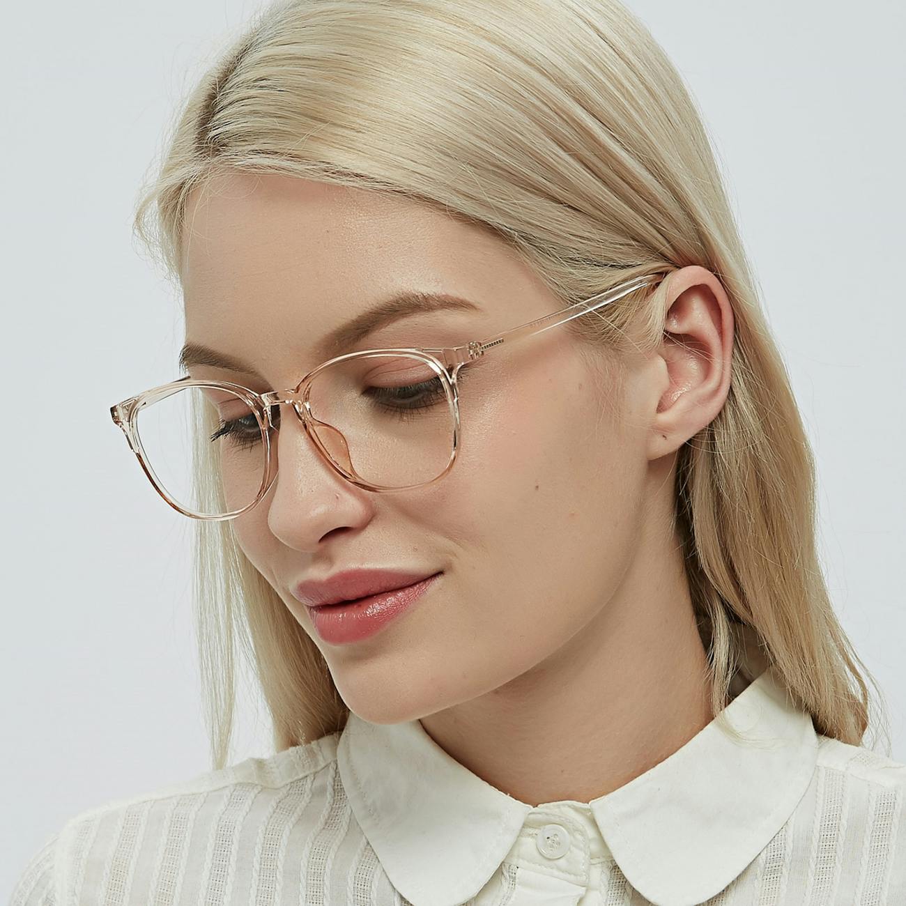 Close-up studio portrait of an elegant young woman wearing eyeglasses and a white shirt, exuding confidence.