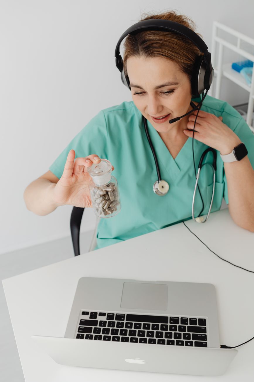 Healthcare practitioner discusses medication in an online consultation, showcasing telemedicine.