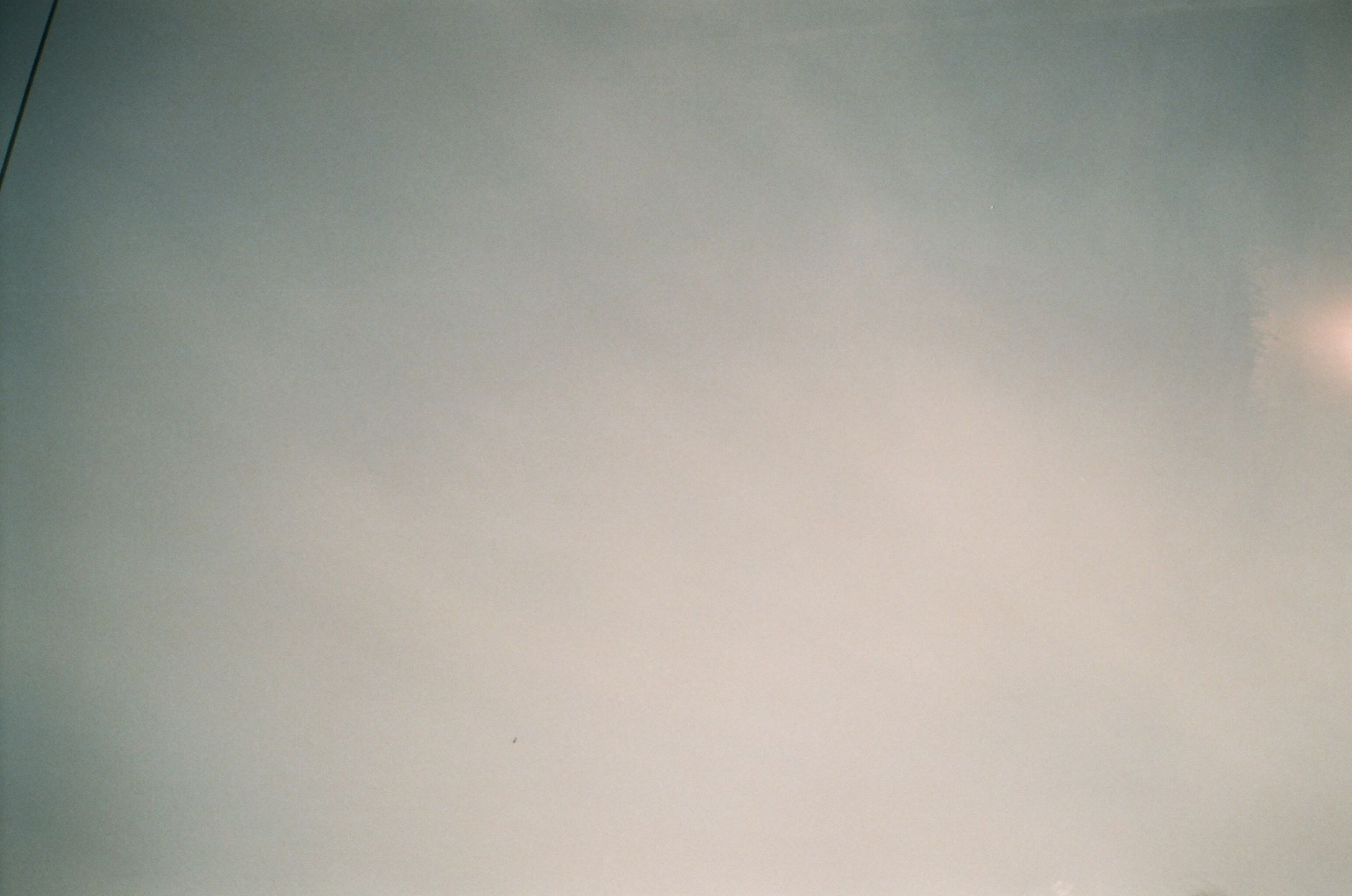 A serene view of a clear sky with soft clouds, perfect for background or design work.