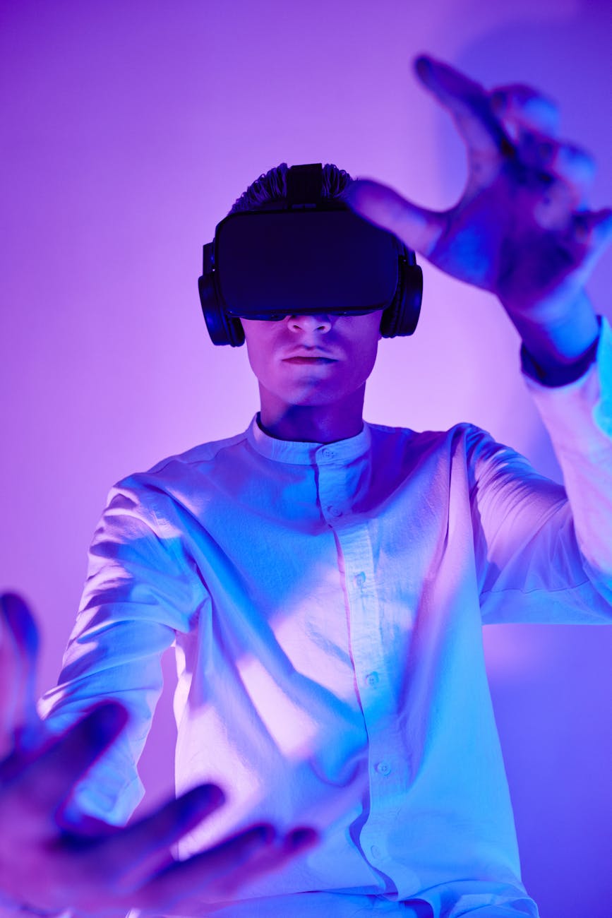 Person immersed in virtual reality using VR goggles in a vibrant studio setting.