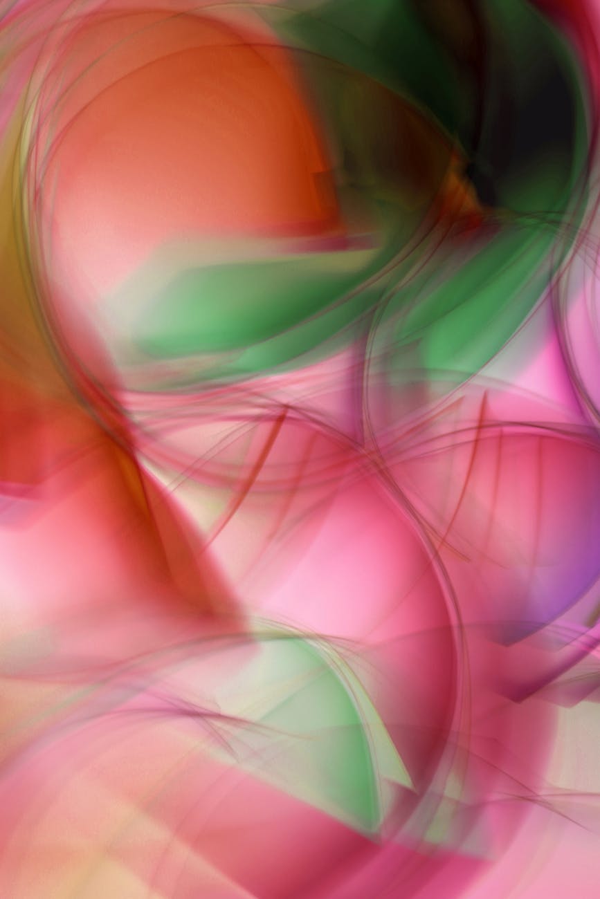 Dynamic abstract art featuring swirling colors of pink, green, and orange, creating a vivid and energetic composition.