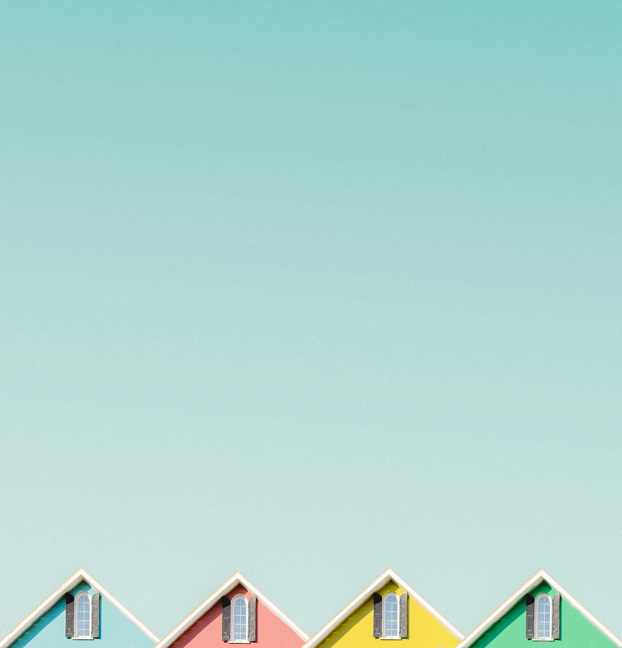 Aesthetic view of vibrant house roofs under a clear turquoise sky in Buffalo, NY.