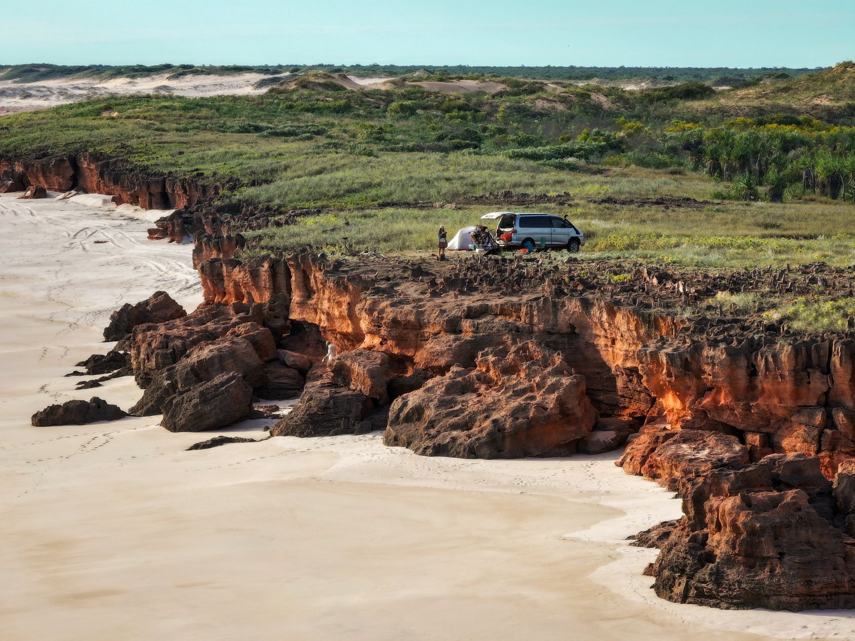 Scenic aerial view of campervan and tent on Dampier Peninsula cliffs, Western Australia.