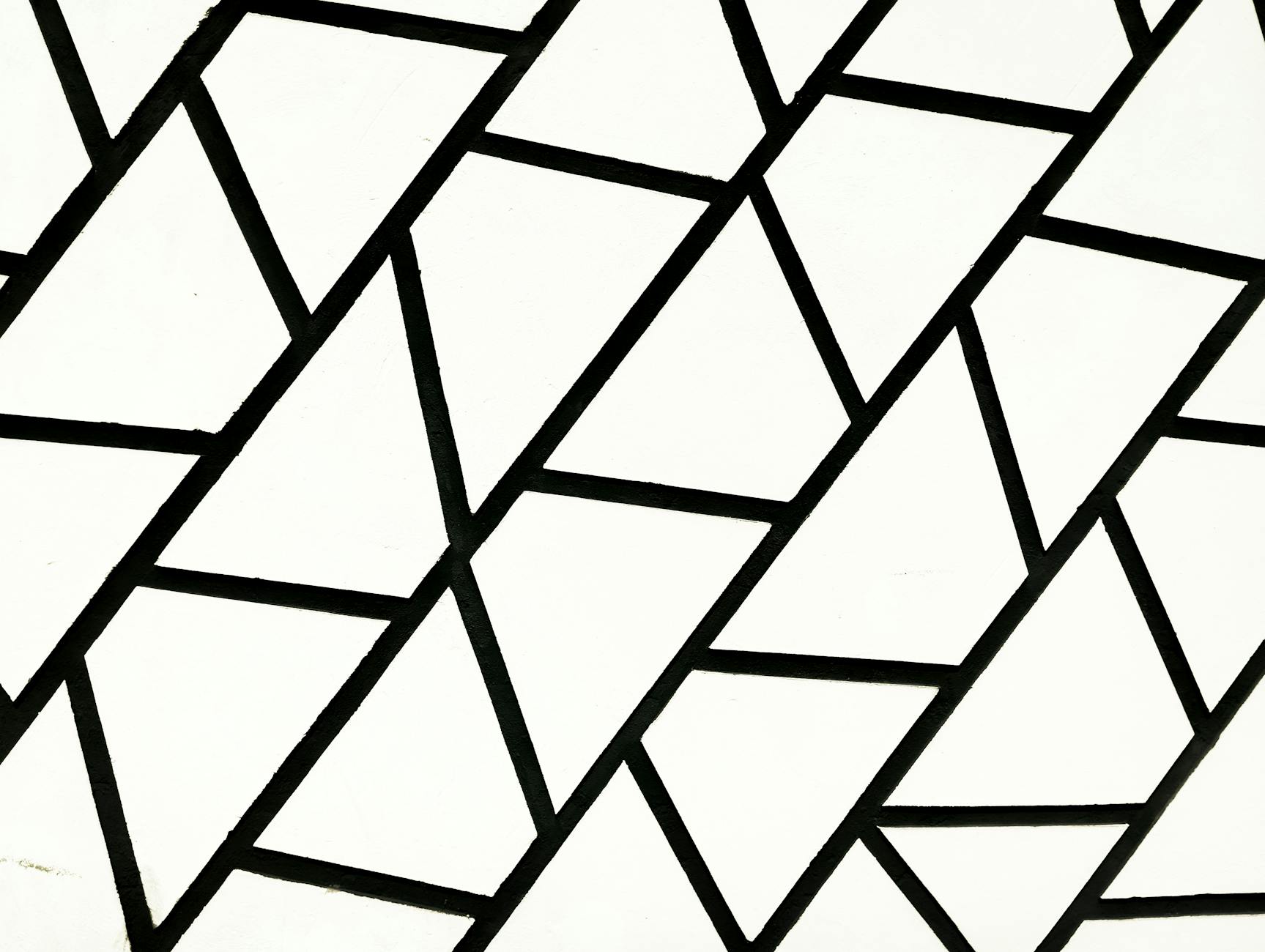 Black and white geometric pattern with triangular shapes, creating a bold and modern design.