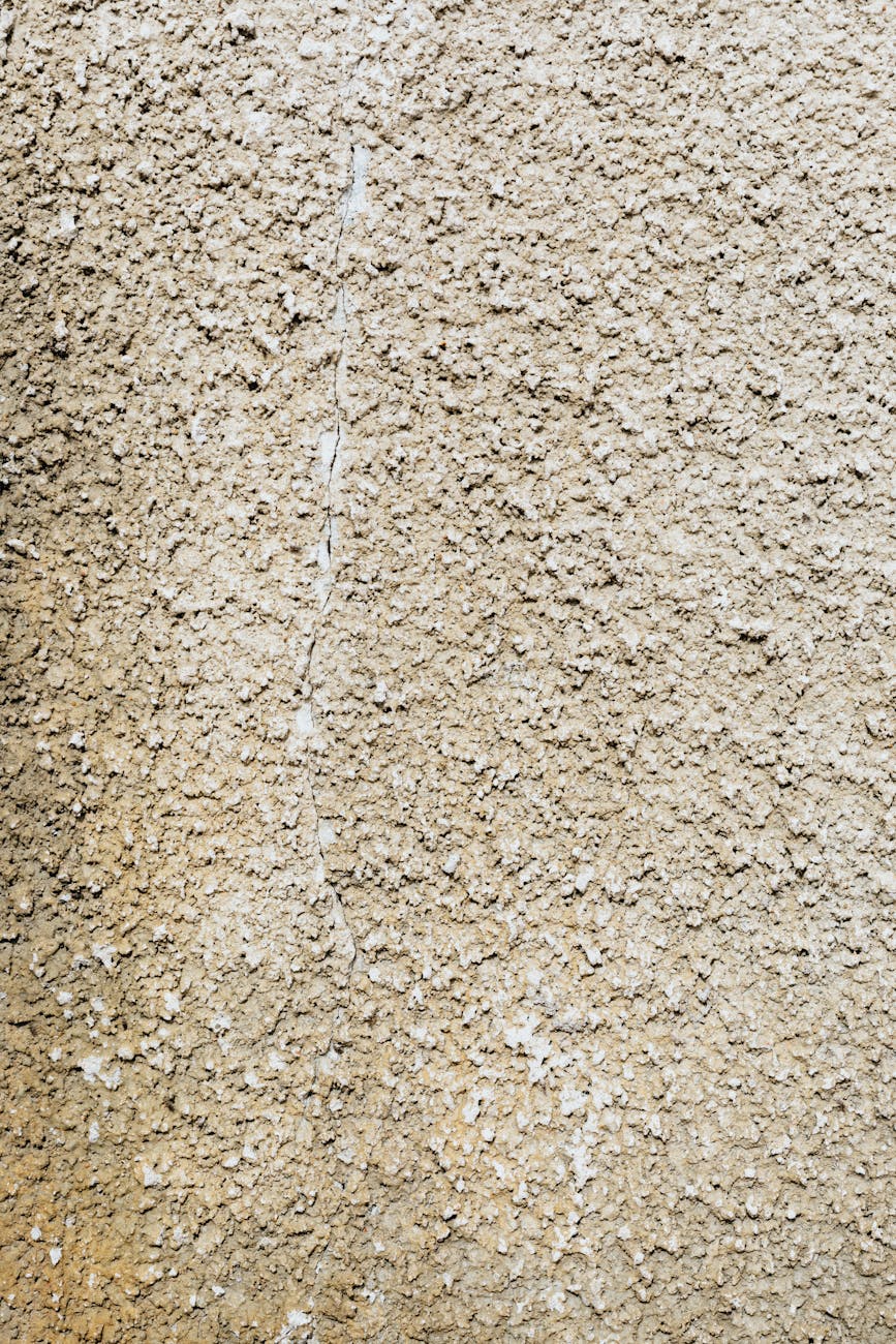 Close-up of a textured concrete wall with rough surface patterns.