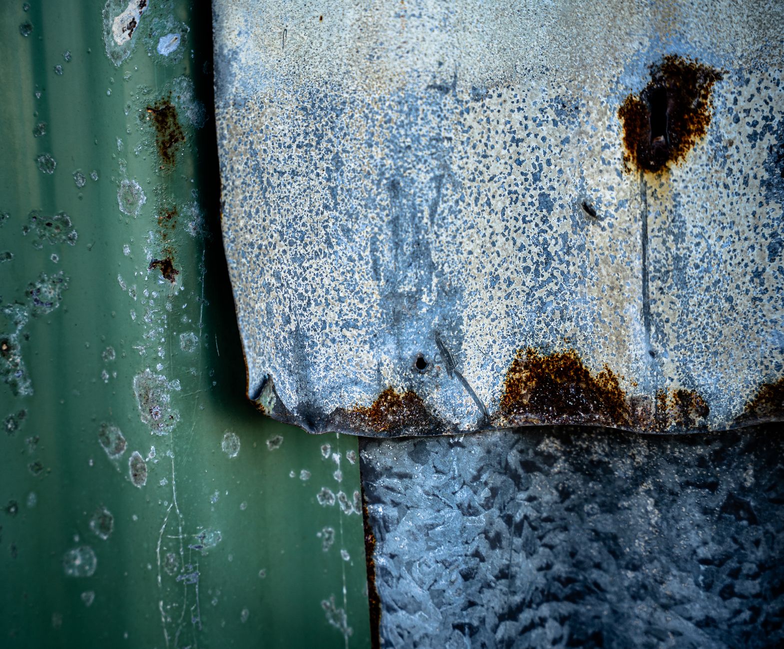 Detailed texture of rusty and weathered corrugated metal, showcasing patina and decay.