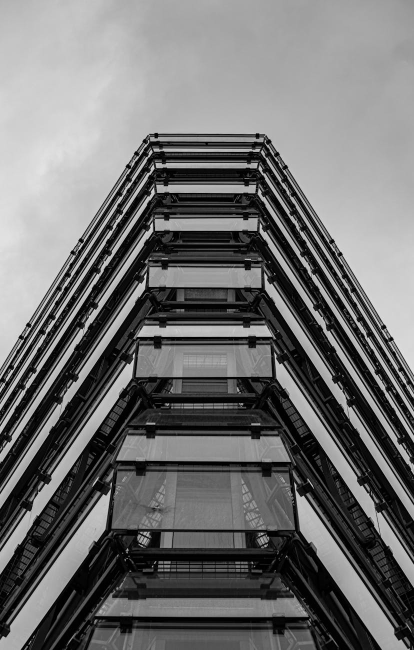 Low angle view of a modern building in Berlin showcasing architectural elegance in monochrome.