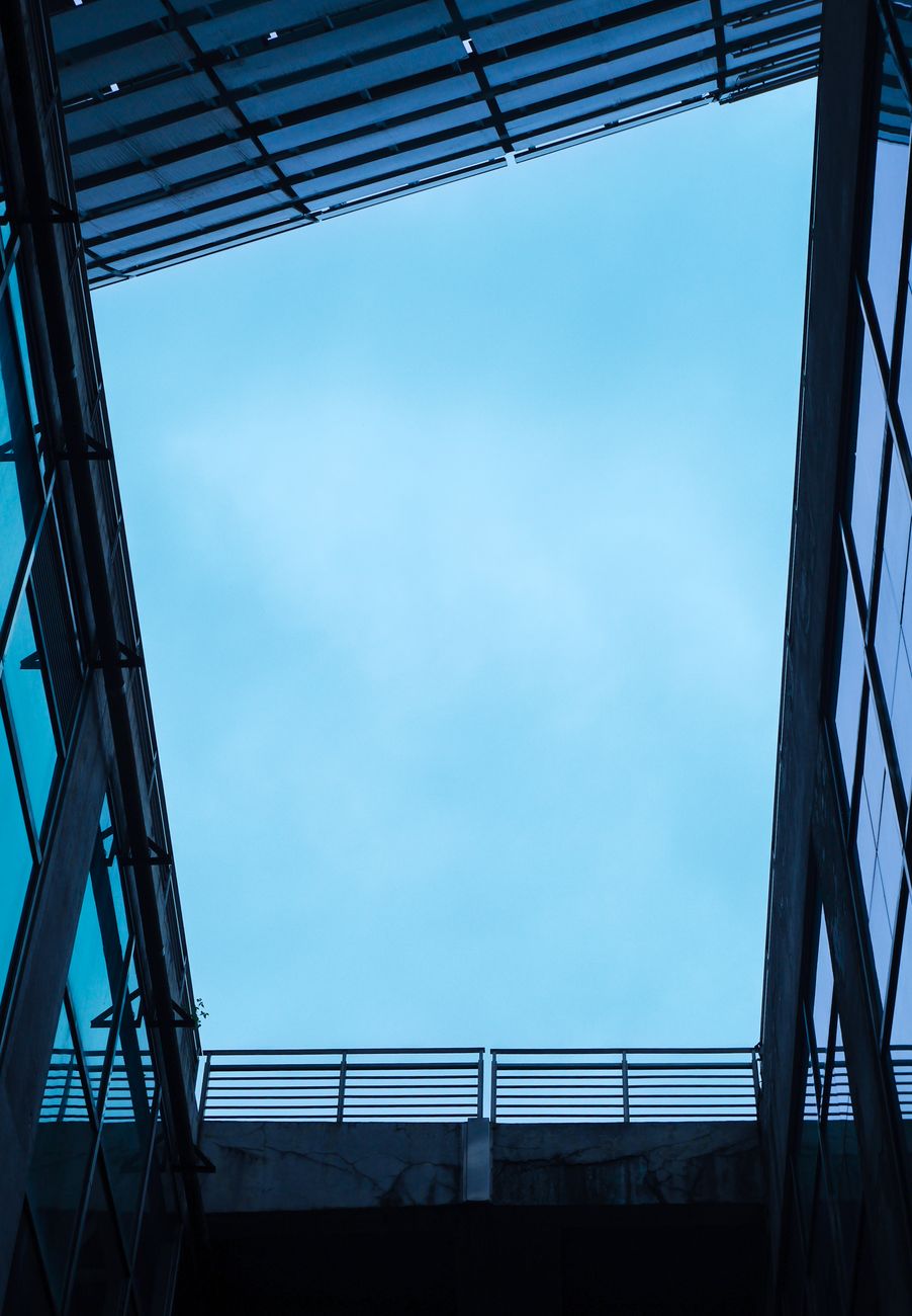 A striking view of contemporary architecture framing a serene blue sky.