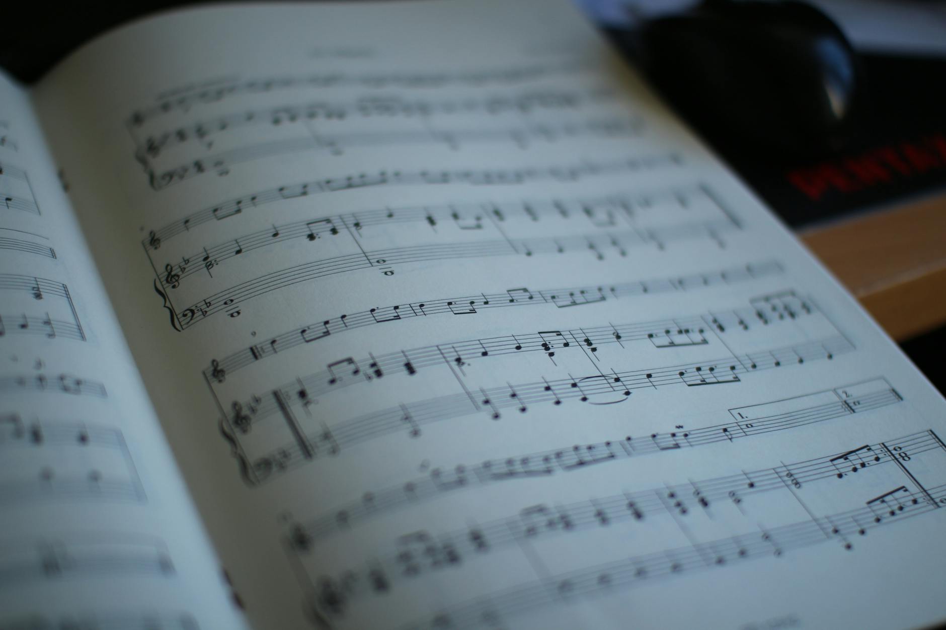 Detailed close-up of an open music book showing sheet music notes.