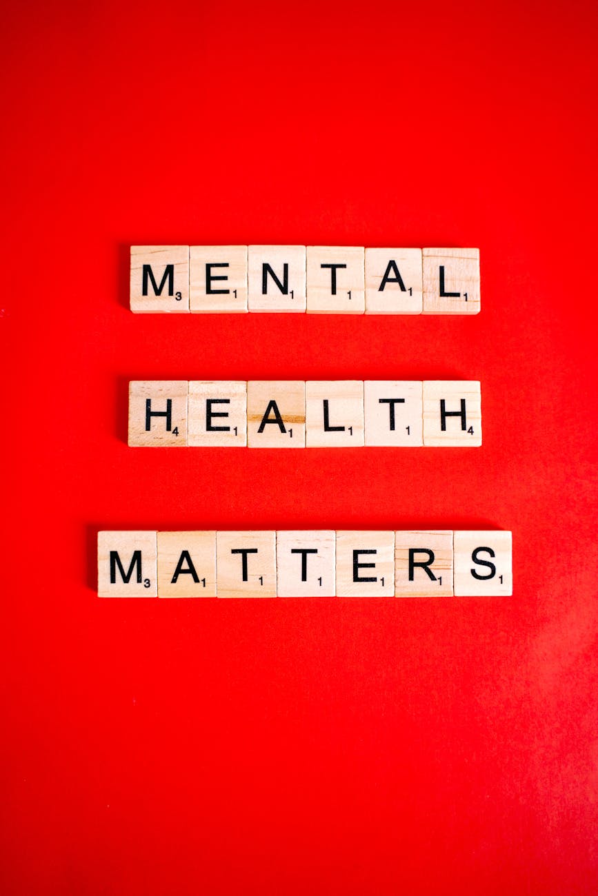 Wooden letter tiles spelling 'Mental Health Matters' on a red background.