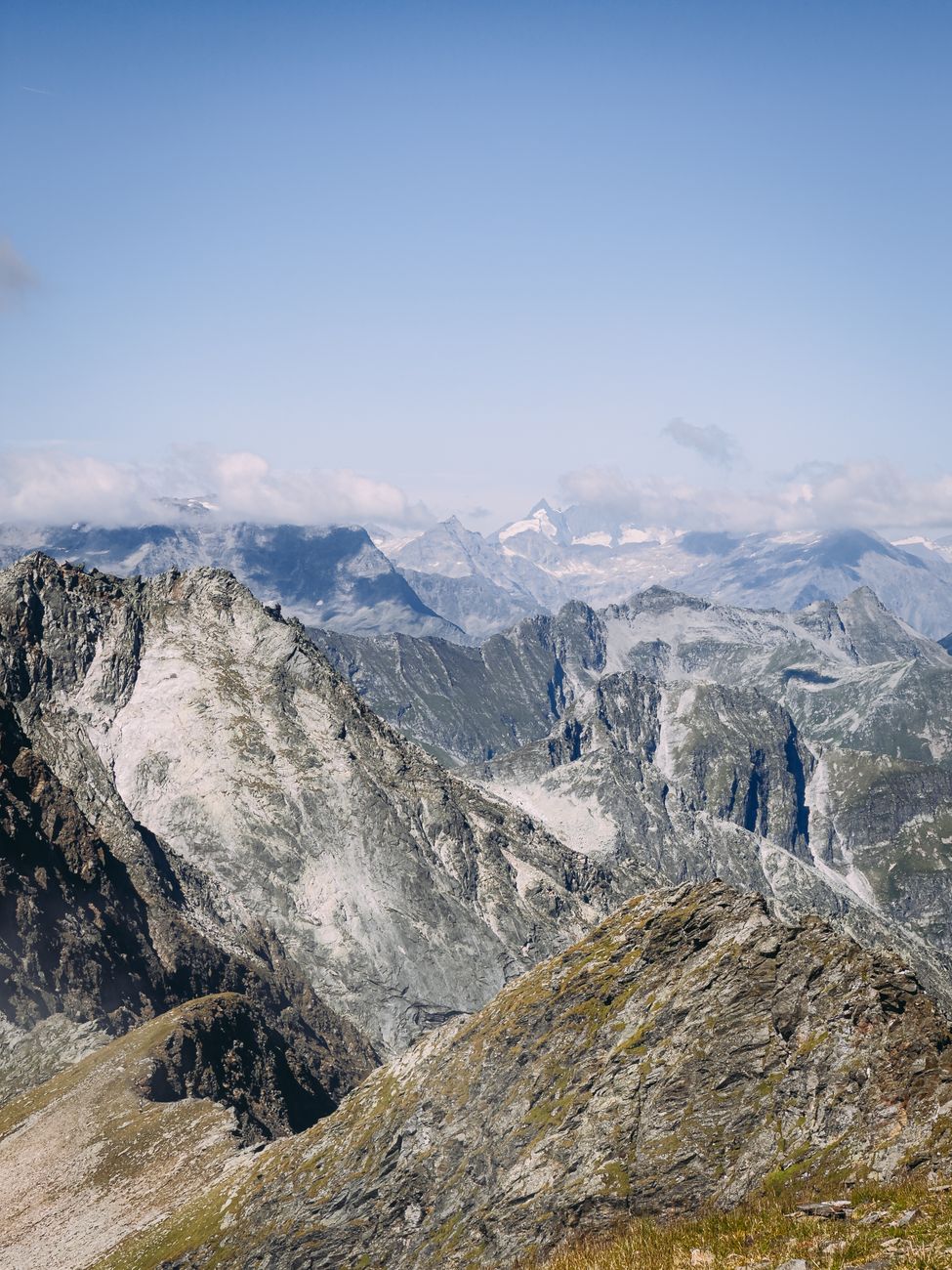Breathtaking view of rugged alpine mountains under clear blue sky, perfect for travel and nature enthusiasts.