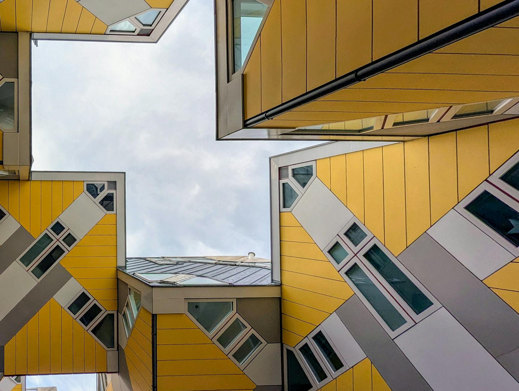 Geometric perspective looking up at the famous Cube Houses in Rotterdam, Netherlands.