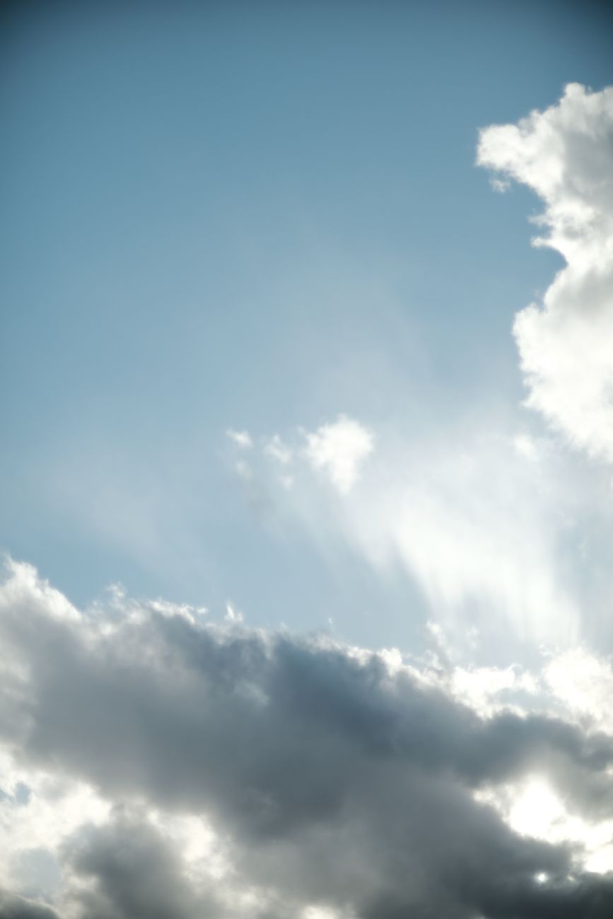A calming sky view featuring clouds and sunlight breaking through, perfect for relaxation themes.