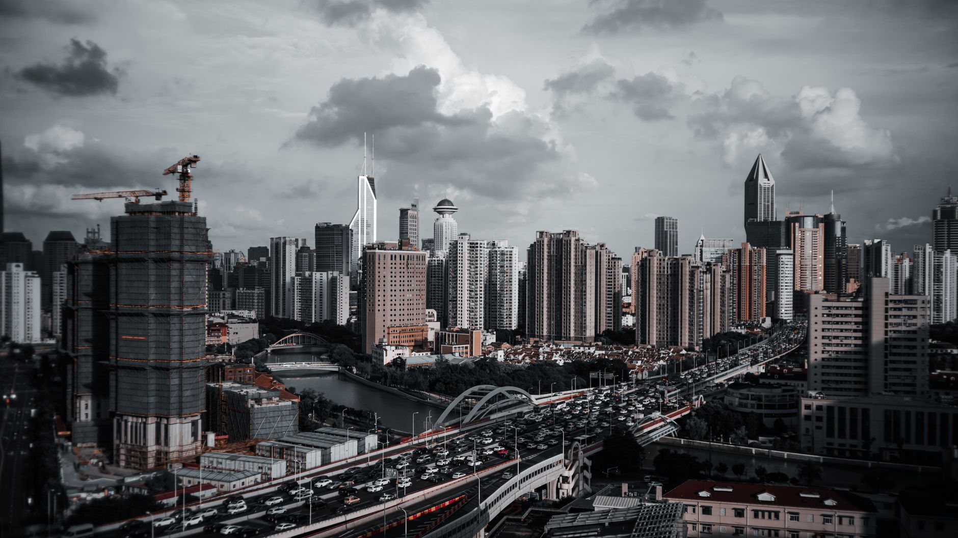 A vibrant cityscape featuring a modern skyline with skyscrapers, bridges, and urban traffic.